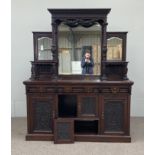 A large late Victorian oak sideboard, circa 1890, with the stepped and mirrored gallery back over