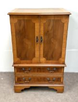 A modern yew veneered tv cabinet, with two cabinet doors, over two drawers