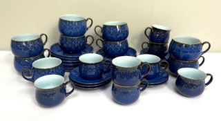 A Denby china part dinner service, in Royal blue with stylised flower decoration, with various
