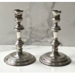 A pair of silver Queen Anne style candlesticks, hallmarked London 1960, each with a knopped stem and