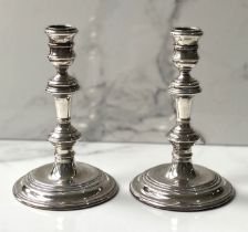 A pair of silver Queen Anne style candlesticks, hallmarked London 1960, each with a knopped stem and