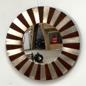 A modern decorative circular wall mirror, with silvered barred frame