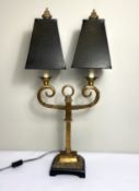 A gilt metal 19th century style twin light table lamp stand, with scrolled arms