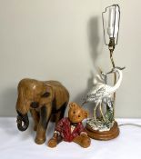 A modern table lamp base, with figures of Heron; together with a carved wood elephant and a teddy