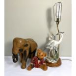 A modern table lamp base, with figures of Heron; together with a carved wood elephant and a teddy