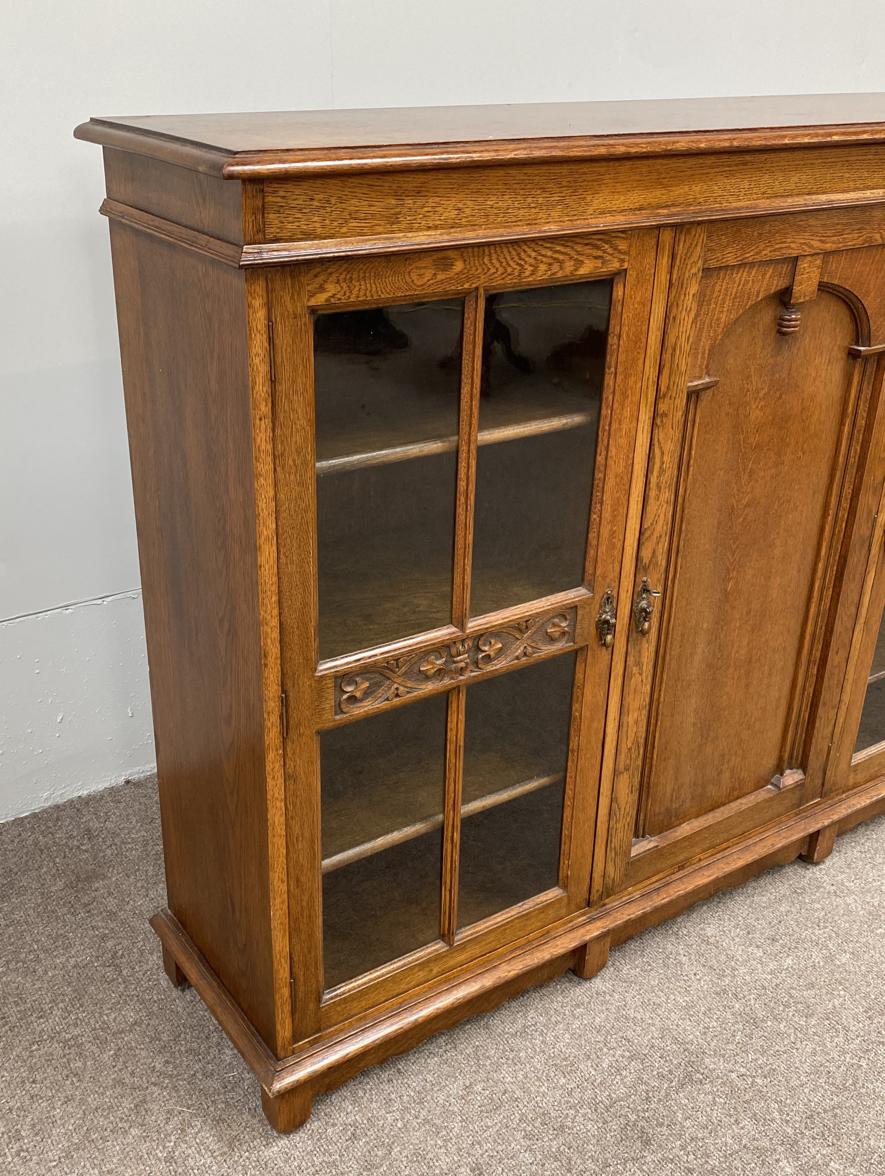 A vintage oak china cabinet, with a central arch moulded door and flanked by two glazed doors, - Image 8 of 8