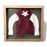 A framed set of horse racing Jockey Silks, for ‘Carlingford Castle’, 1983, ridden by Willie