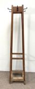 An oak hat stand, early 20th century with four plain square angled legs, the top with four coat/