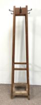 An oak hat stand, early 20th century with four plain square angled legs, the top with four coat/