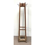 An oak hat stand, early 20th century with four plain square angled legs, the top with four coat/