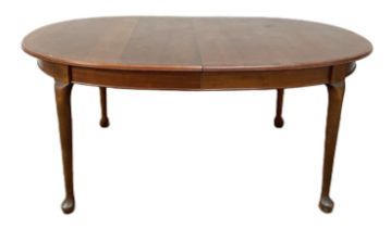 A small vintage Victorian style mahogany dining table, with oval top on four legs with pad feet