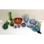 A collection of assorted coloured glass, including paperweights, a large orange glass bowl and