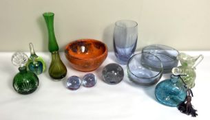 A collection of assorted coloured glass, including paperweights, a large orange glass bowl and
