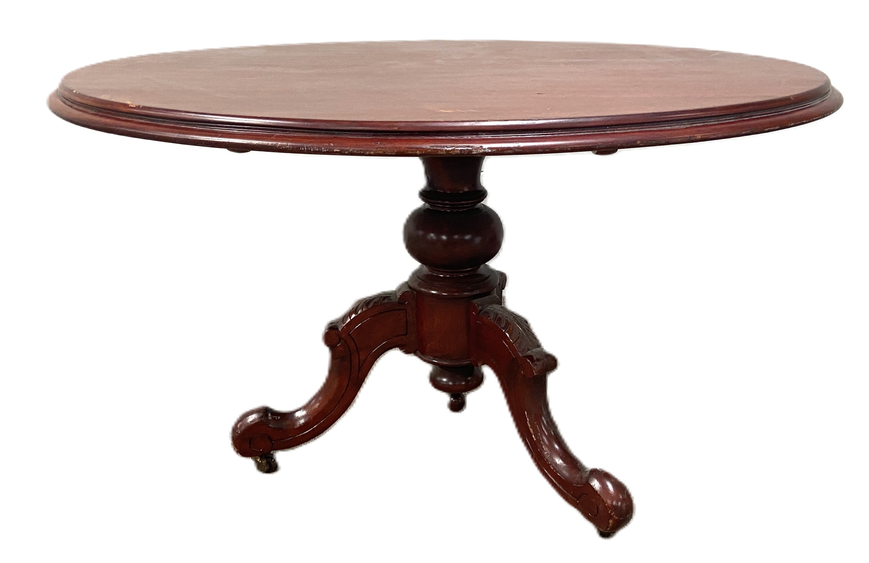 A late Victorian mahogany breakfast table, with circular top and set on a turned and carved pedestal