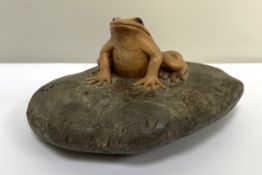 A charming carved wood frog, contemporary, naturalistically carved seated, with glass eyes and set