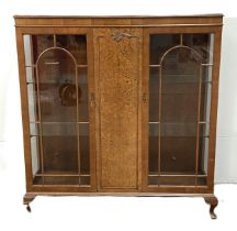 A vintage George III reproduction china display cabinet, with burr walnut veneered central door,