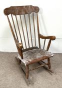 A vintage beech framed rocking chair, 20th century, with spindle back and turned legs and rocker