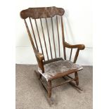 A vintage beech framed rocking chair, 20th century, with spindle back and turned legs and rocker