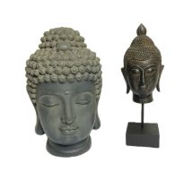 Two decorative heads of Buddha, both with downcast eyes and elaborate head dress (2)