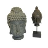 Two decorative heads of Buddha, both with downcast eyes and elaborate head dress (2)