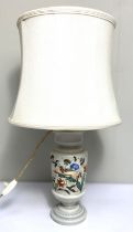 A modern decorative table lamp, the ceramic base painted with a bird and flowers