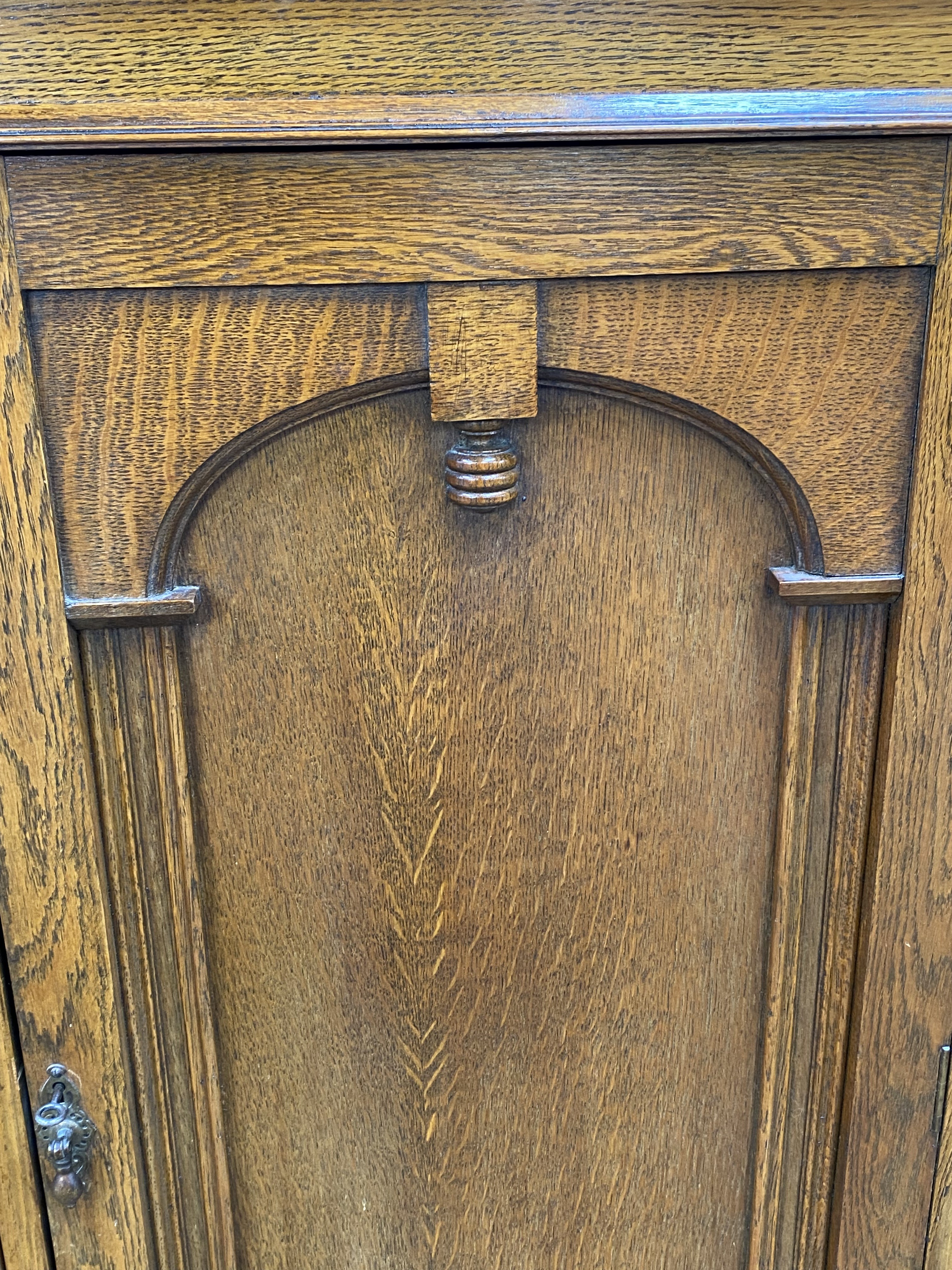 A vintage oak china cabinet, with a central arch moulded door and flanked by two glazed doors, - Image 7 of 8