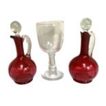 A good pair of vintage Ruby glass ewers, together with a very large glass goblet, probably mid