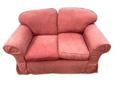 A modern two seater sofa, with padded back and cushions, currently upholstered in red cotton damask