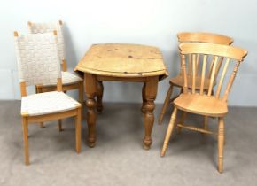 A small modern circular pine table, together with two pine kitchen chairs and two other modern