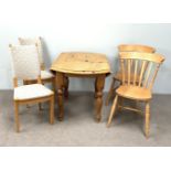 A small modern circular pine table, together with two pine kitchen chairs and two other modern