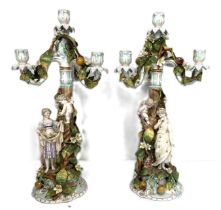 A fine pair of Sitzendorf porcelain figural candelabra, 19th century, each with a removable four