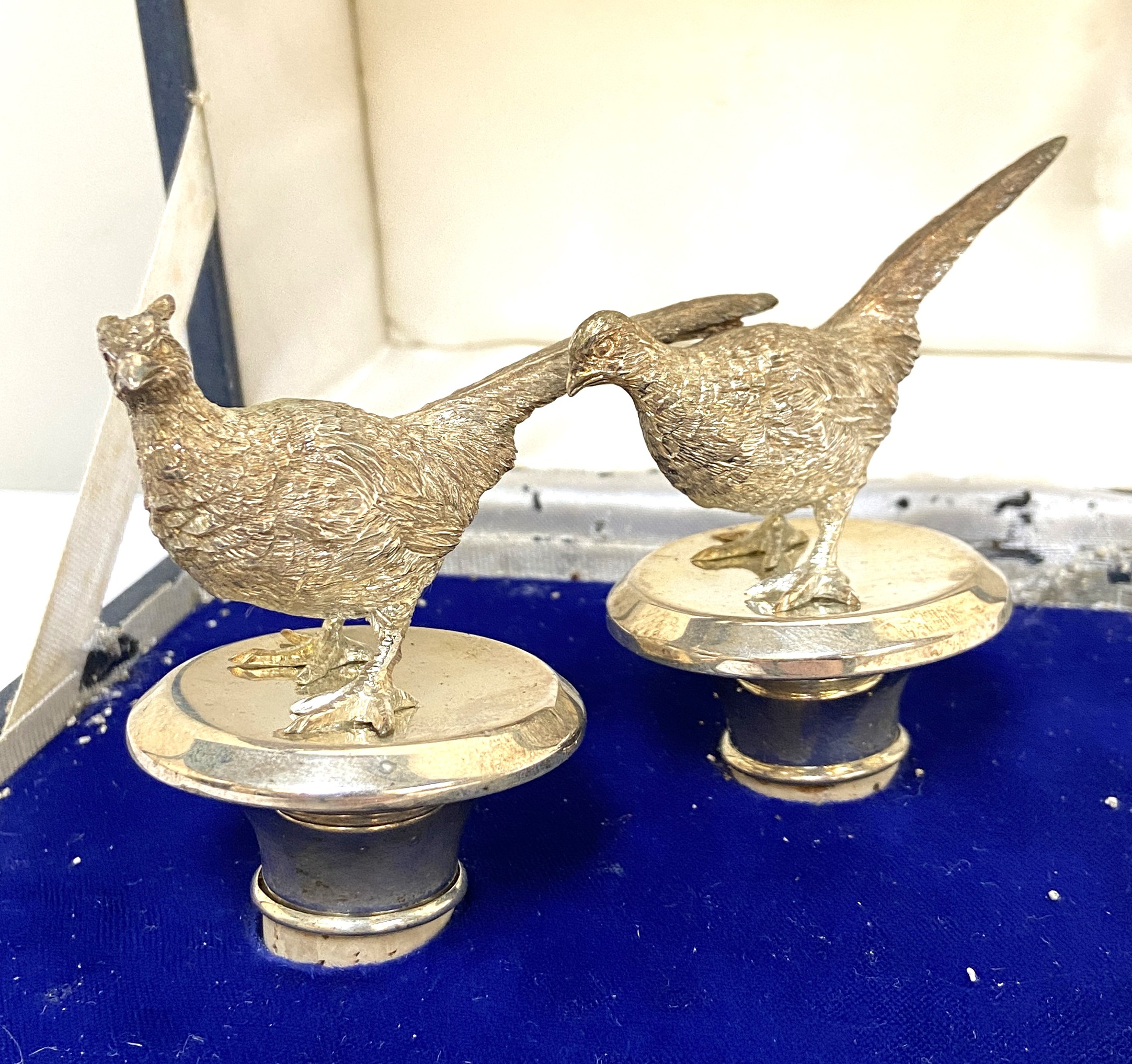 A pair of silver novelty bottle stoppers, with Cock Pheasant terminals, hallmarked London, 1982,