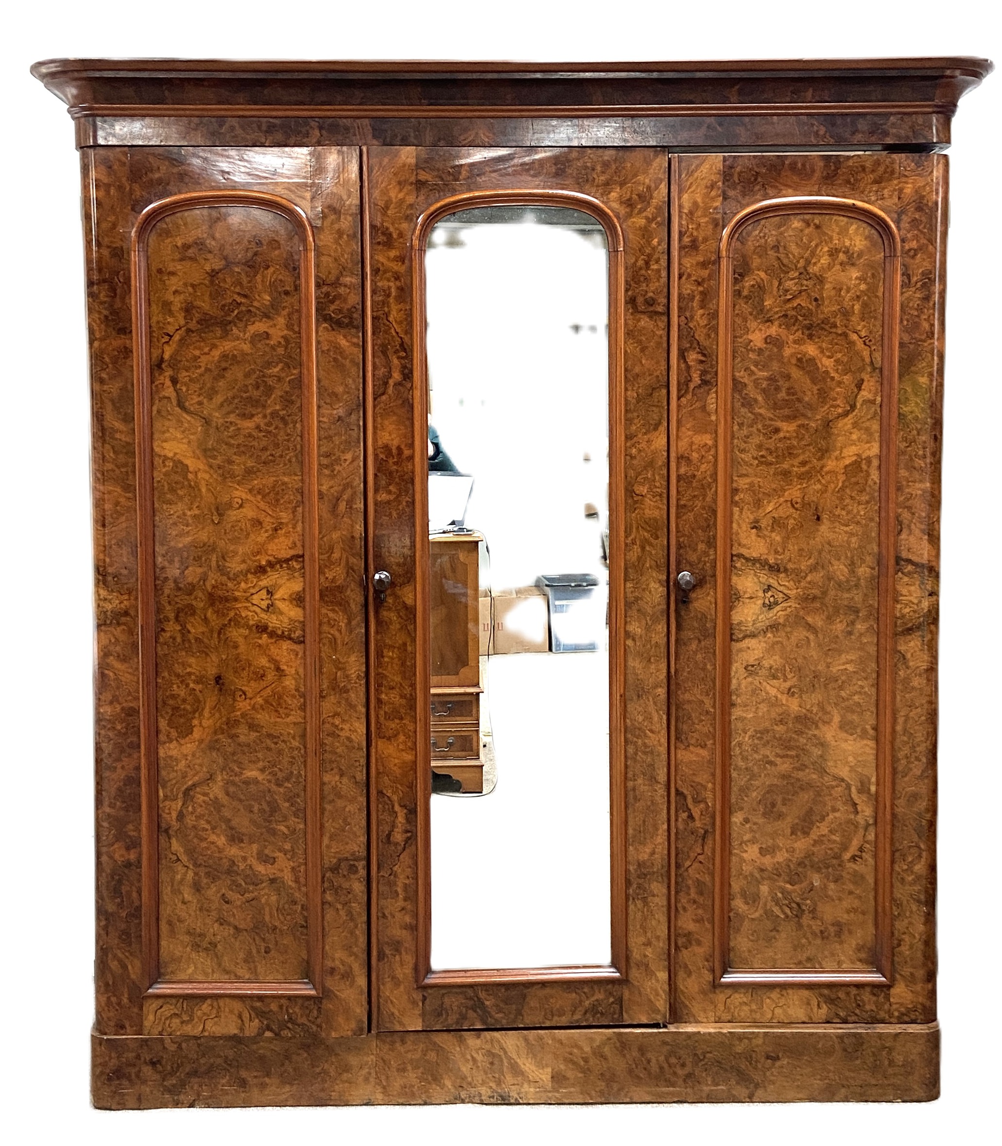 A mid Victorian burr walnut veneered triple wardrobe, circa 1870, with a central arch moulded