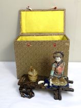 A Chinese ceramic figure of a seated lady, resting on a wooden pier with her water bucket, 28cm