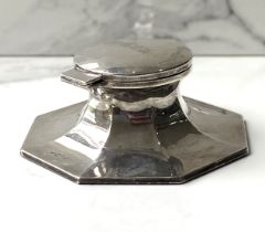 A silver capstan inkwell, hallmarked Chester 1936, with hinged lid, inset glass well, and