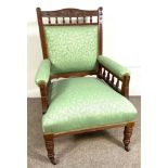 A late Victorian Gentleman's easy armchair, with bobbin turned and padded back and arms, turned legs