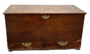 A George III mahogany blanket chest, with hinged lid, opening to reveal candle drawers, the base
