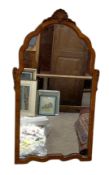 Three assorted wall mirrors, including a shell carved arched mirror, an oval mirror and a