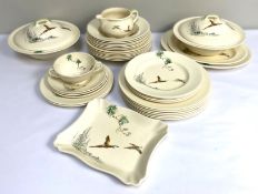 A Royal Doulton part dinner service, all decorated with a brace of pheasants, including two