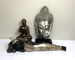 Three modern decorative figures of the Buddha, including a large reclining figure; a 'silvered' head