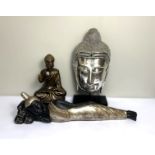 Three modern decorative figures of the Buddha, including a large reclining figure; a 'silvered' head