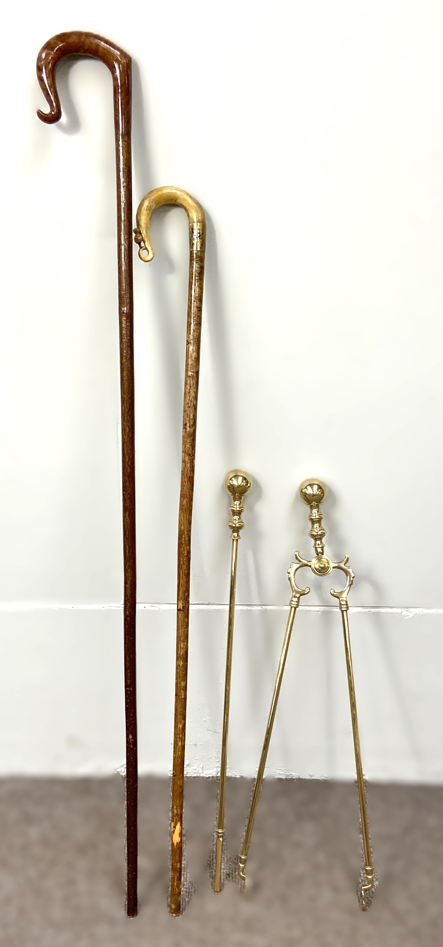 Two Scottish walking sticks, one with a carved horn handle, decorated with a thistle, the other of