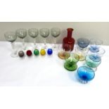 A selection of coloured glassware, including a ruby glass mallet decanter, goblets and a set of