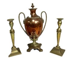 A 19th century copper and brass samovar, together with a pair of large brass candlesticks, the