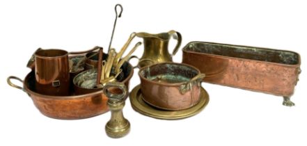 A selection of brass and copper wares, including a graduated set of saucepans, assorted planters,
