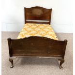 A mid 20th century single bedstead, with panelled head and foot