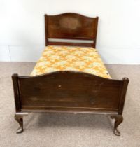 A mid 20th century single bedstead, with panelled head and foot