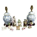 A small group of china figure groups, including two small figures of poodles on cushions; two