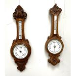 Two Victorian oak cased aneroid wall barometers, late 19th century, both with moulded and carved