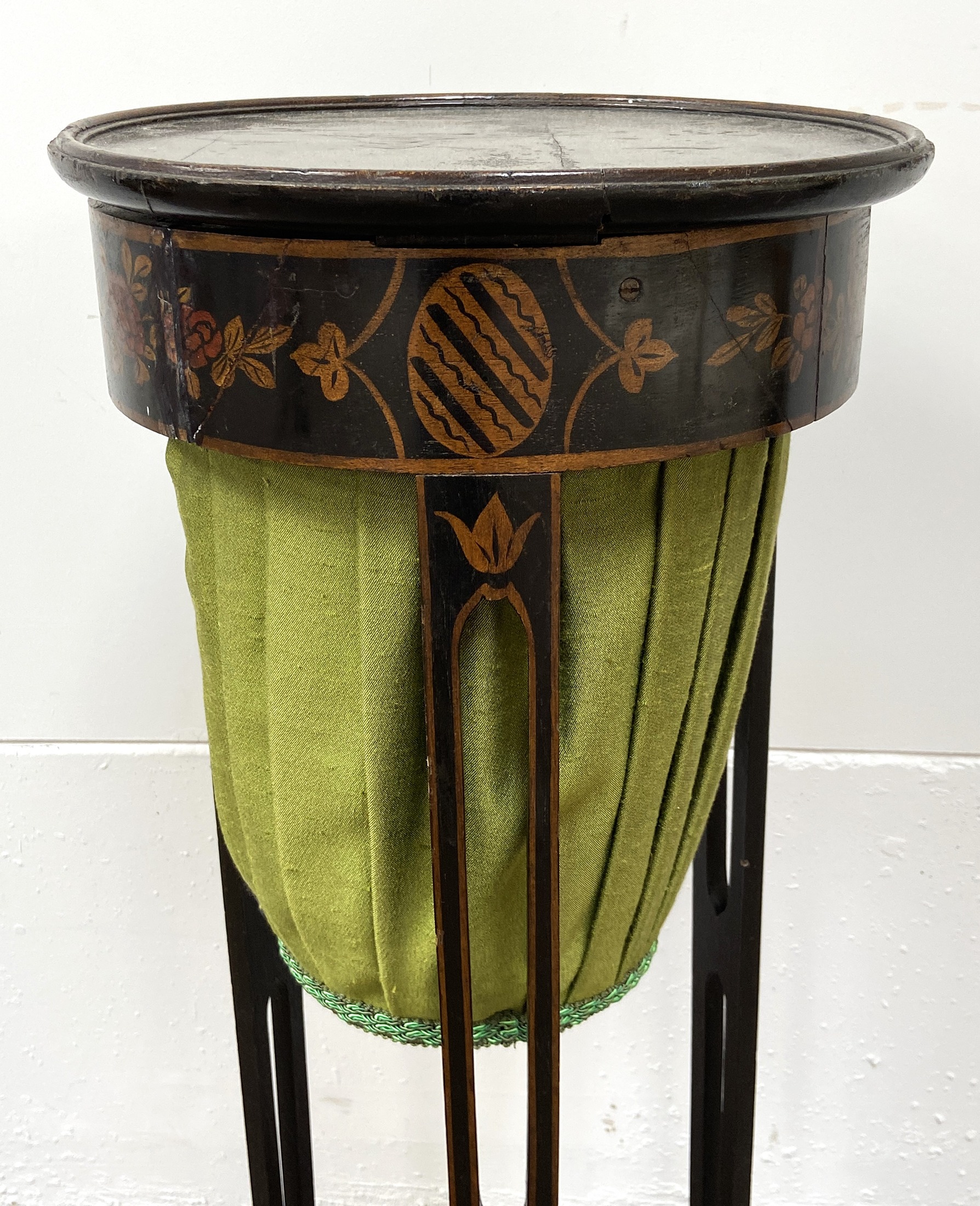 A 19th century Japanned work table, with a hinged circular lid, inner tray and fabric covered basket